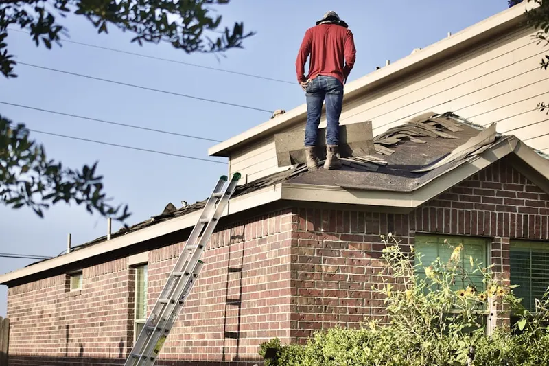 Professional roofer working on a residential roof in Guyton